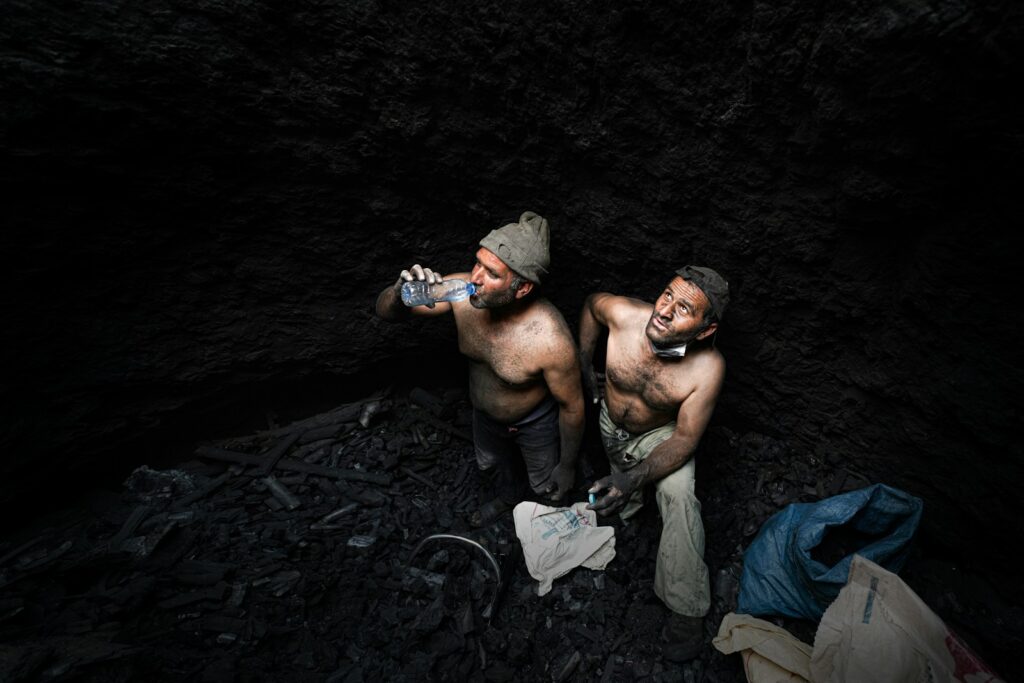 a couple of men drinking beer