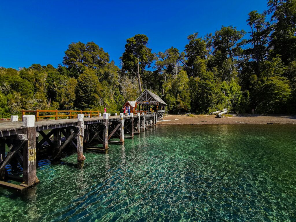 a wooden pier with a small hut on top of it