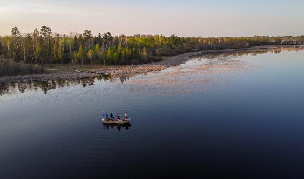 a group of people in a small boat on a lake