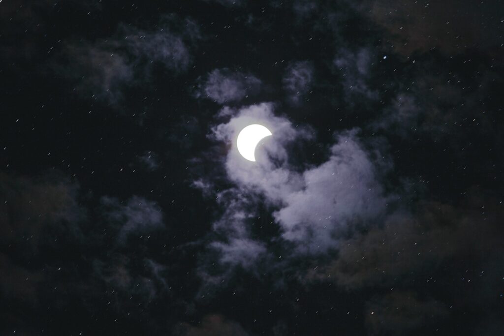 full moon hiding on a cloud