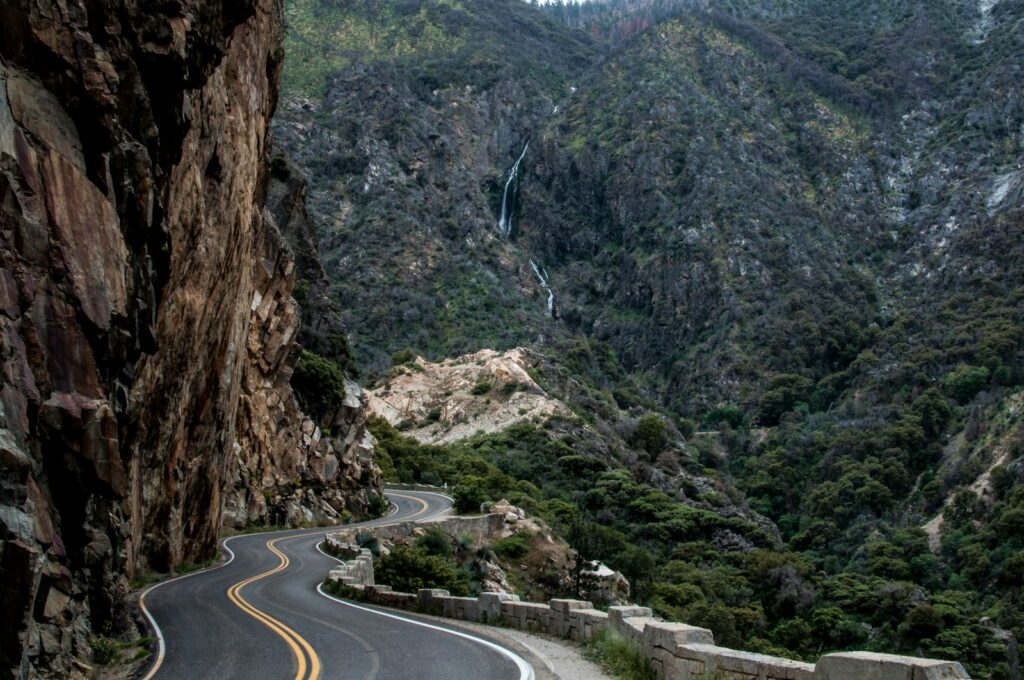 asphalt road beside cliff