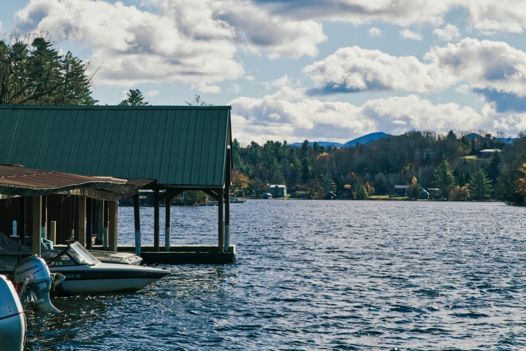 A row of boats sitting on top of a lake