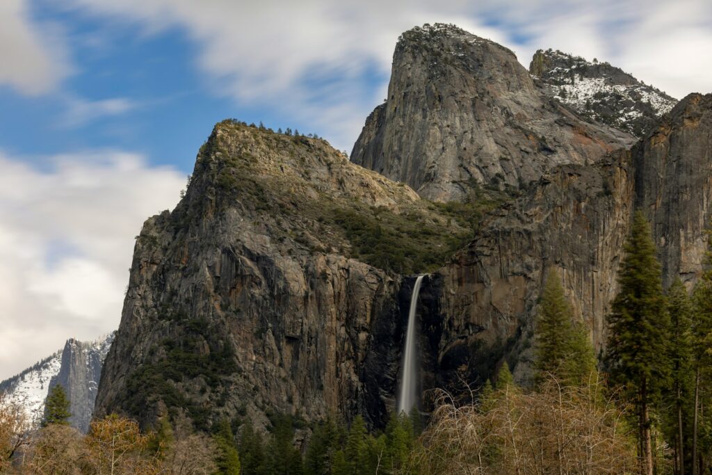 a tall mountain with a waterfall in the middle of it