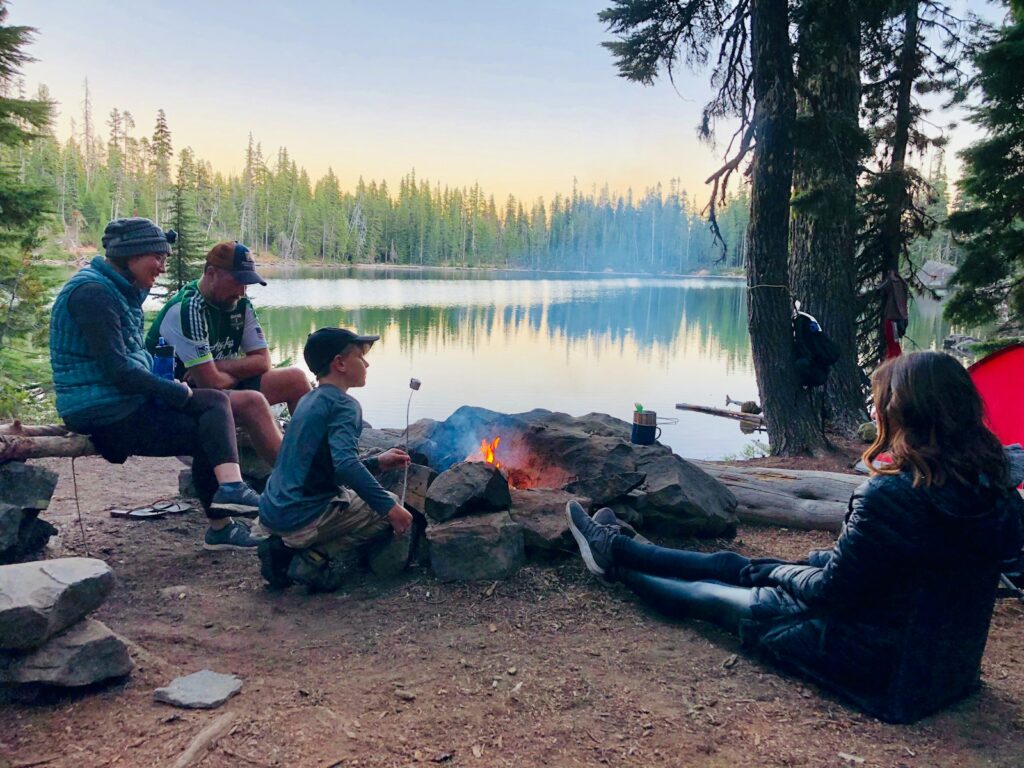 People camping in front of lake.