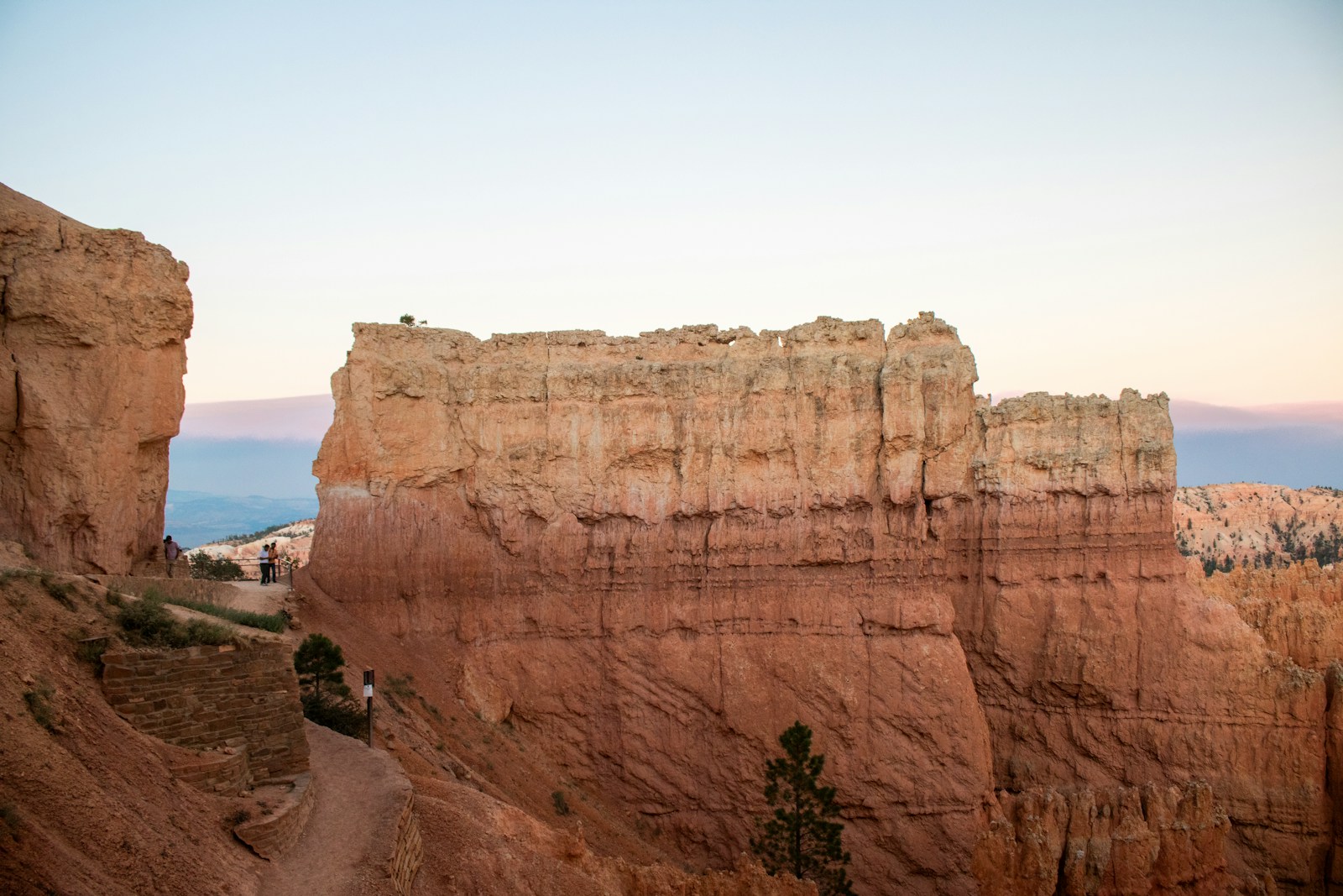 A group of people standing on top of a cliff