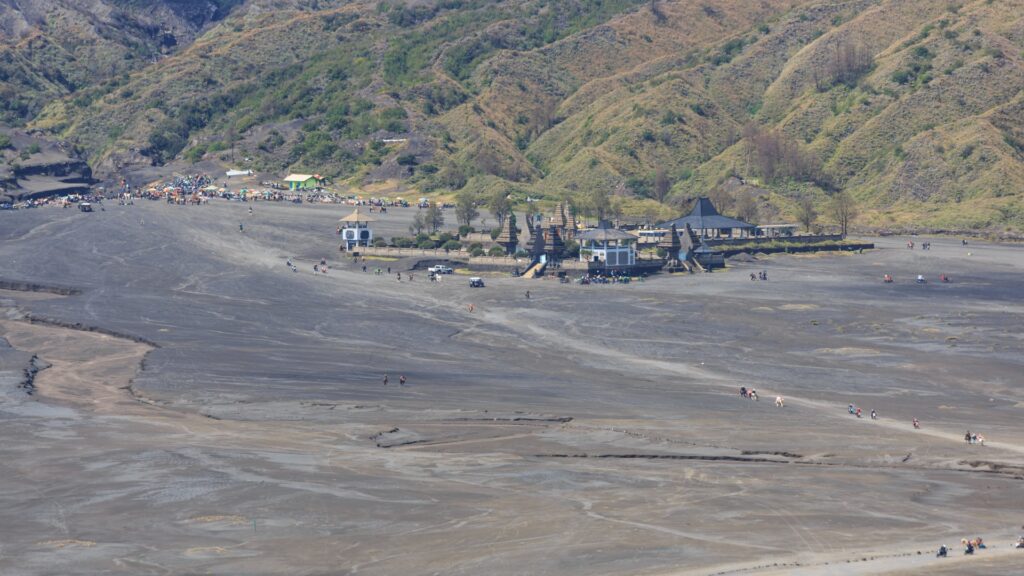 A towering hill with a structure on it, showcasing the natural beauty of Bromo Tengger Semeru National Park.