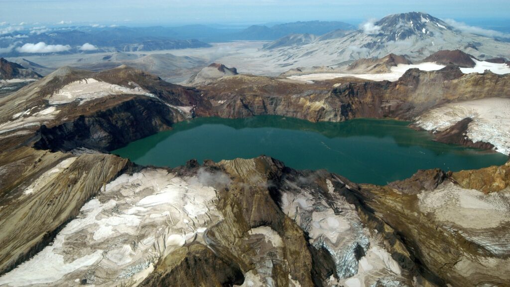 A picturesque lake framed by majestic mountains, highlighting the breathtaking landscape of Katmai National Park.