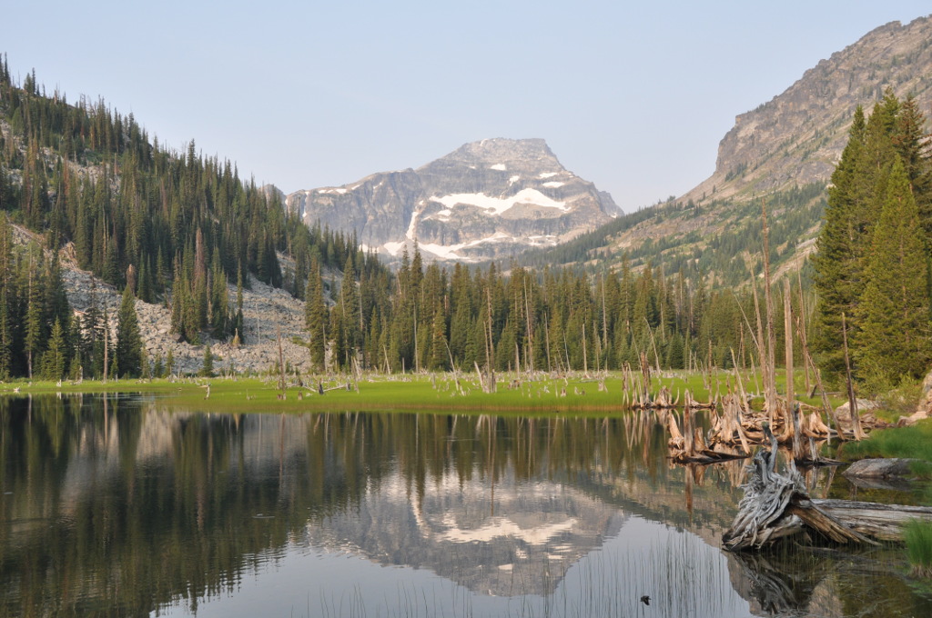 Expansive view of a distant mountain range, showcasing rugged peaks under a clear blue sky.