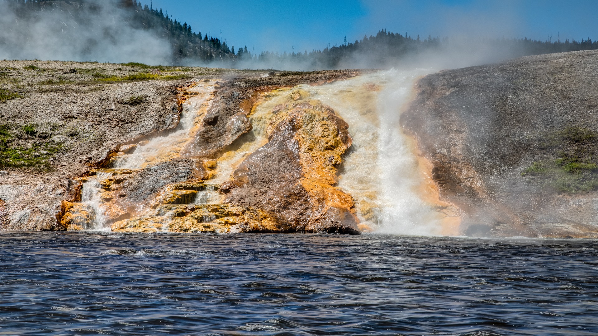 A vibrant geyser in Yellowstone National Park, illustrating the park's unique geothermal activity and breathtaking landscapes.