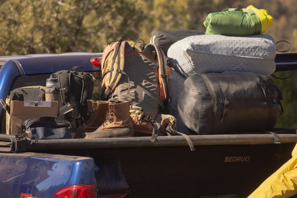 A blue truck filled with colorful luggage, symbolizing a journey full of exploration and travel.