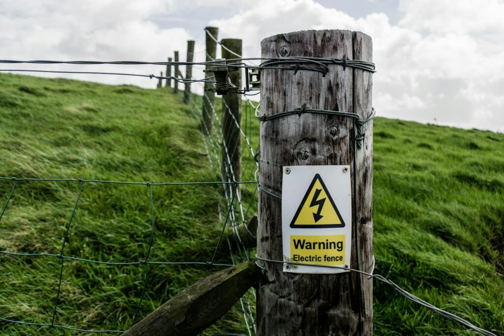 Warning electric sign during daytime.