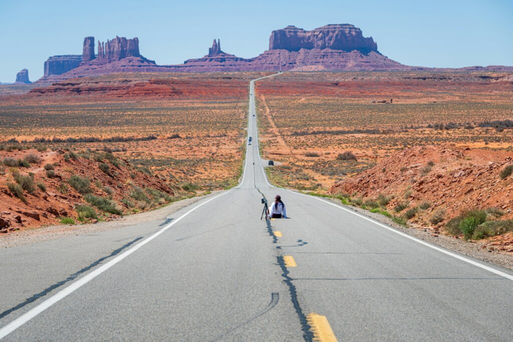 a couple of people that are sitting on a road