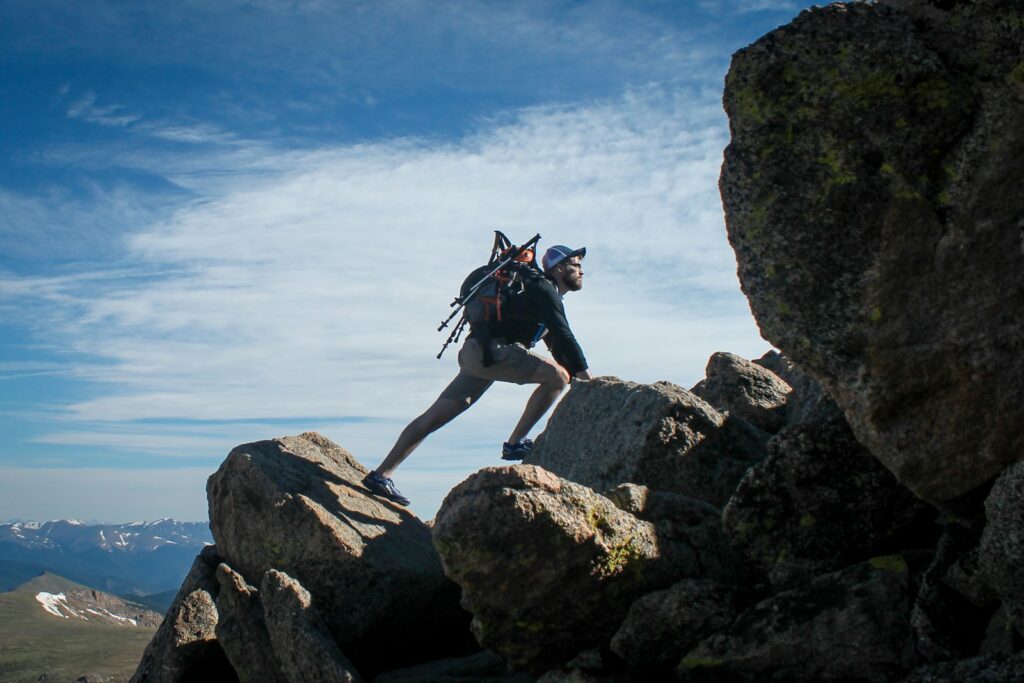 Photo of man climbing mountain.