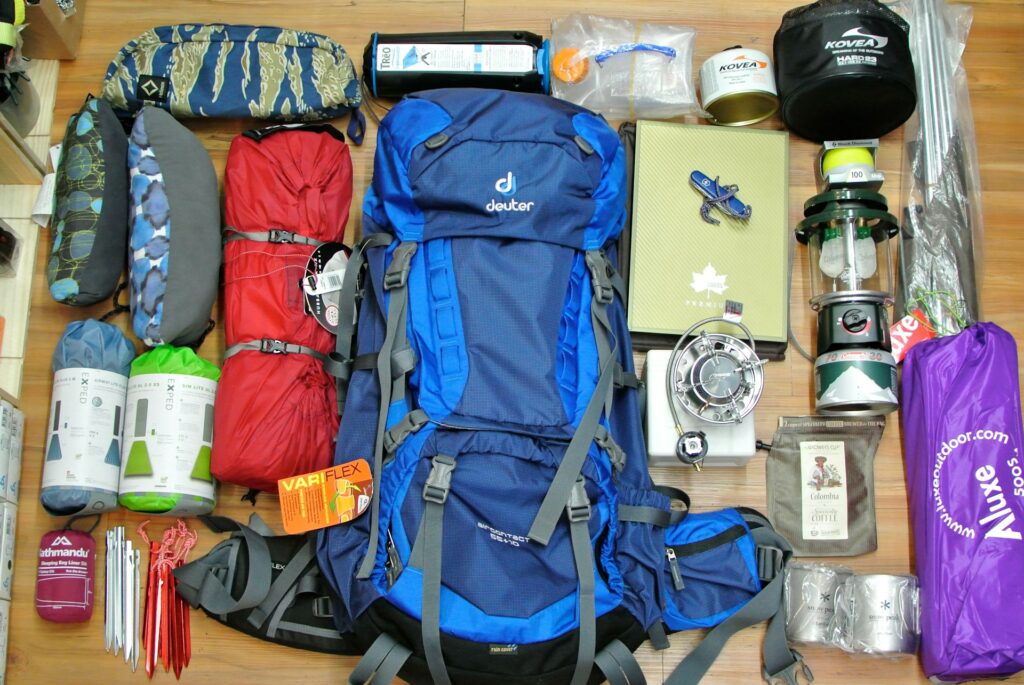 A camping backpack filled with essential gear, including a tent, sleeping bag, and cooking items, for a wilderness trip.