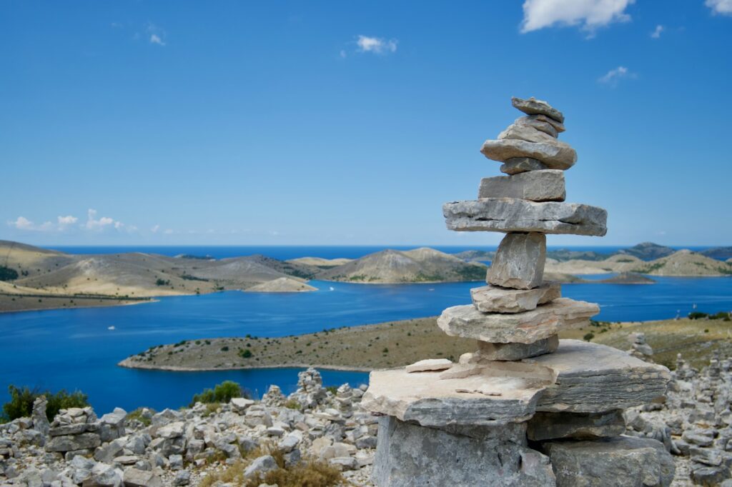 gray rock formation near body of water during daytime