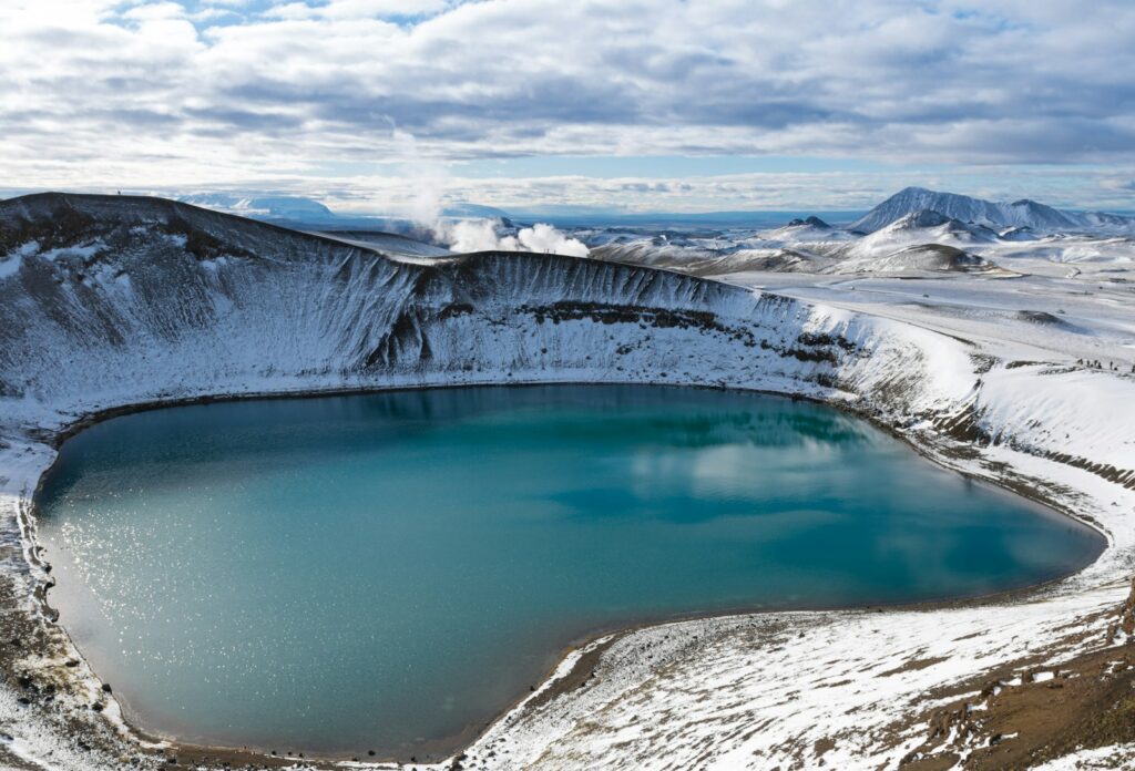 body of water near mountain during daytime