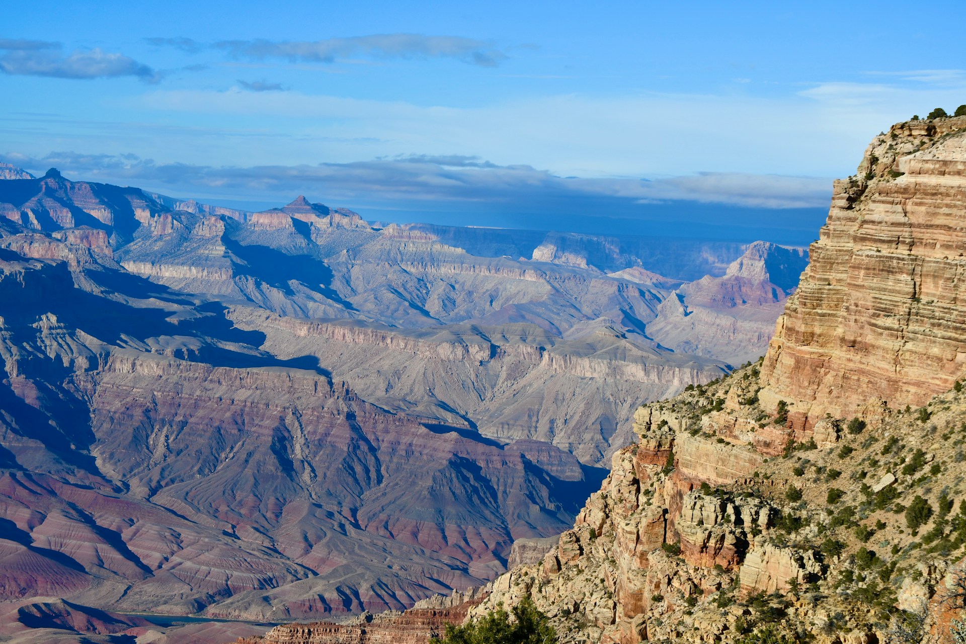 A prominent rock formation rising dramatically from the ground, showcasing natural erosion patterns.