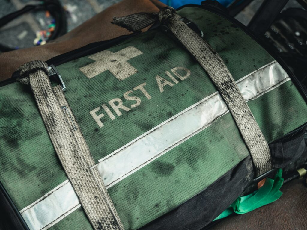 An emergency first aid bag sits atop a chair, emphasizing the importance of health readiness.