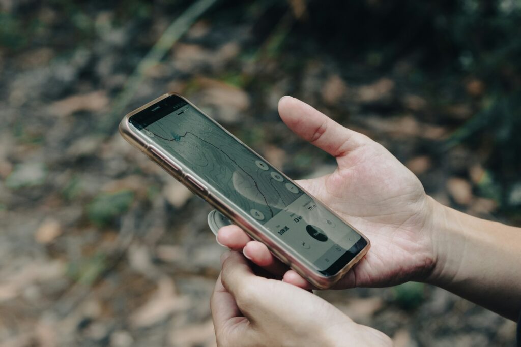 A person holding a cell phone in their hand.