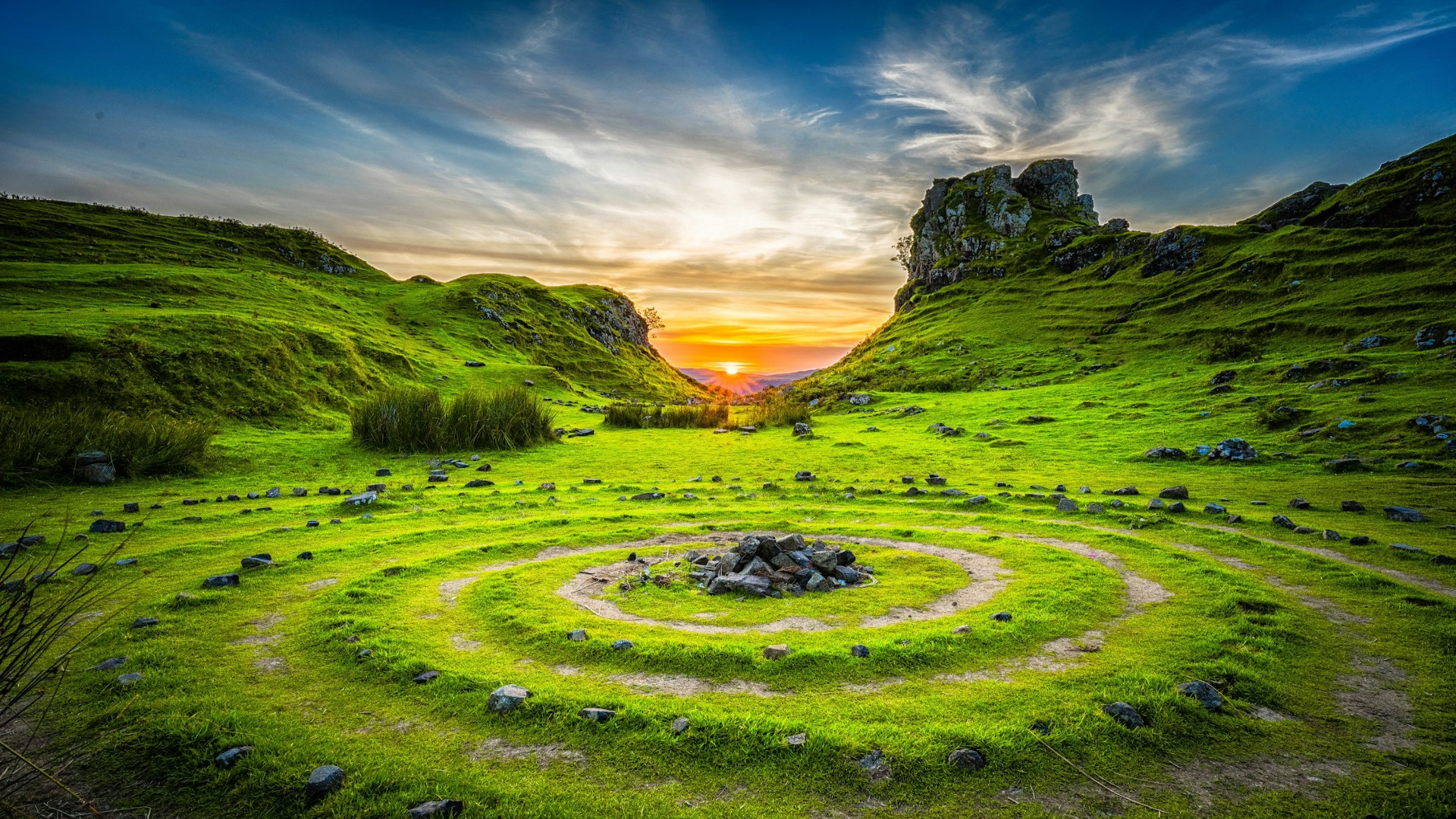 A stone circle set in a vibrant grassy field, showcasing ancient architecture against a serene landscape.