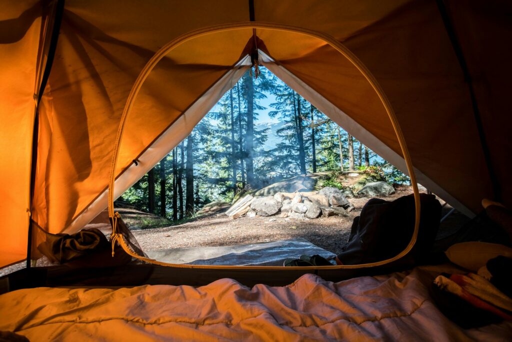 Inside view of a cozy tent, showcasing the fabric walls and a glimpse of the outdoors through the entrance.