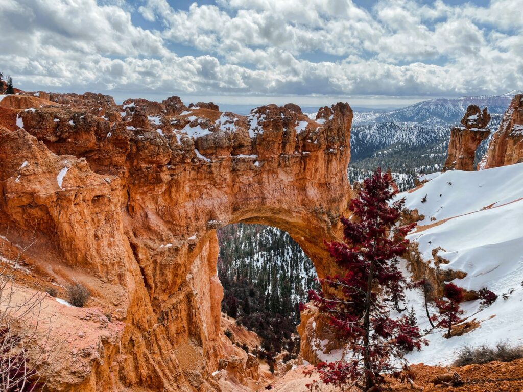 brown rocky mountain under white clouds during daytime
