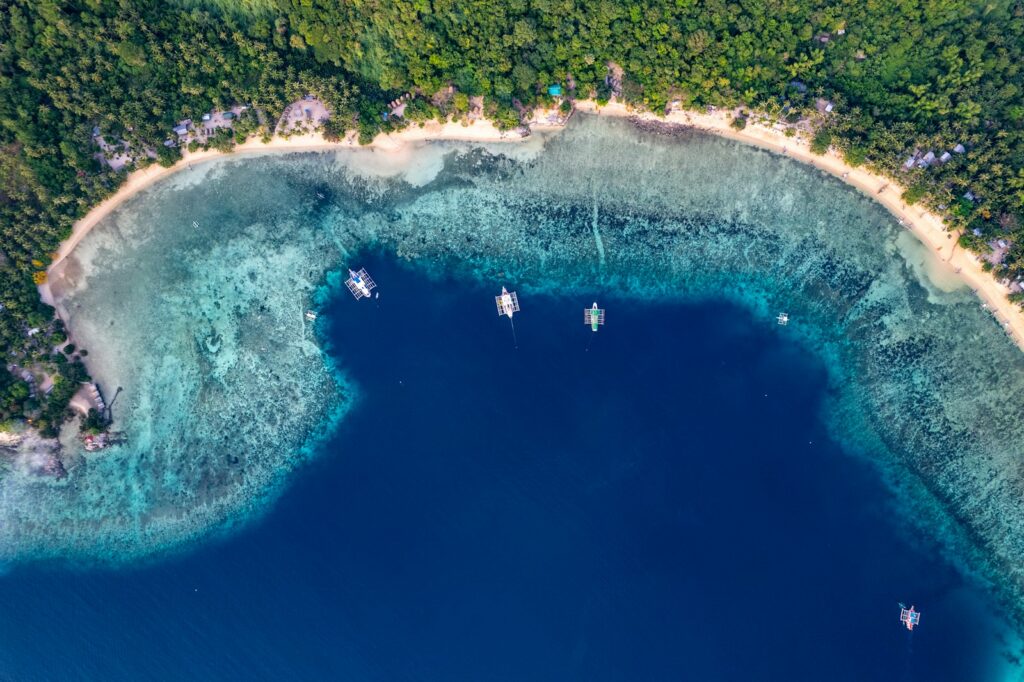 An aerial view of a tropical island with blue water