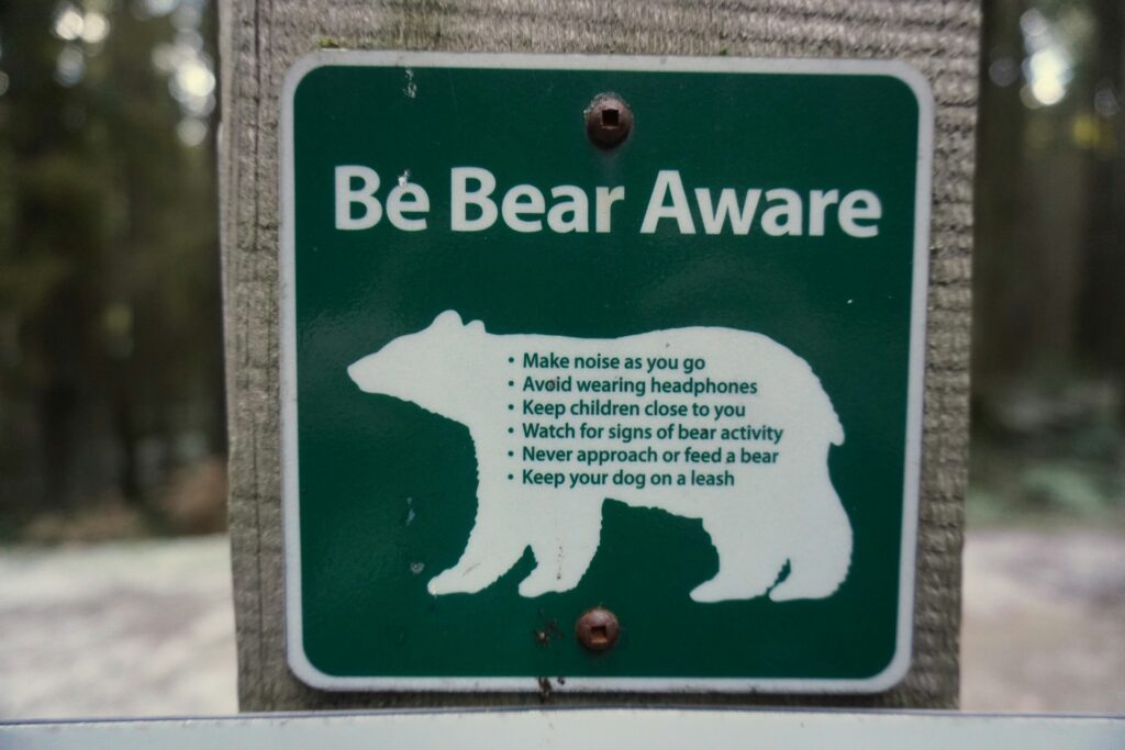 A warning sign displaying the message "Be Bear Aware" to promote safety in bear-populated areas.