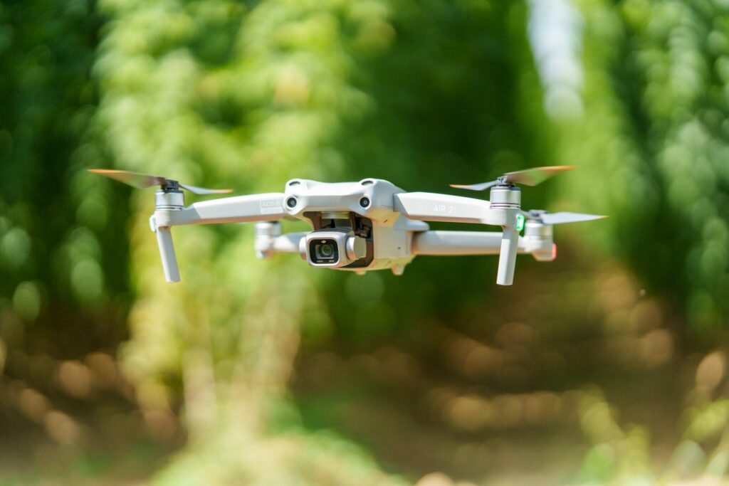 A close up of a camera attached to a small white plane