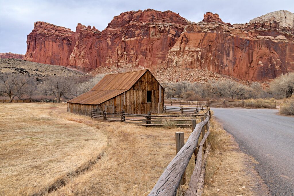 An old barn sits on the side of the road