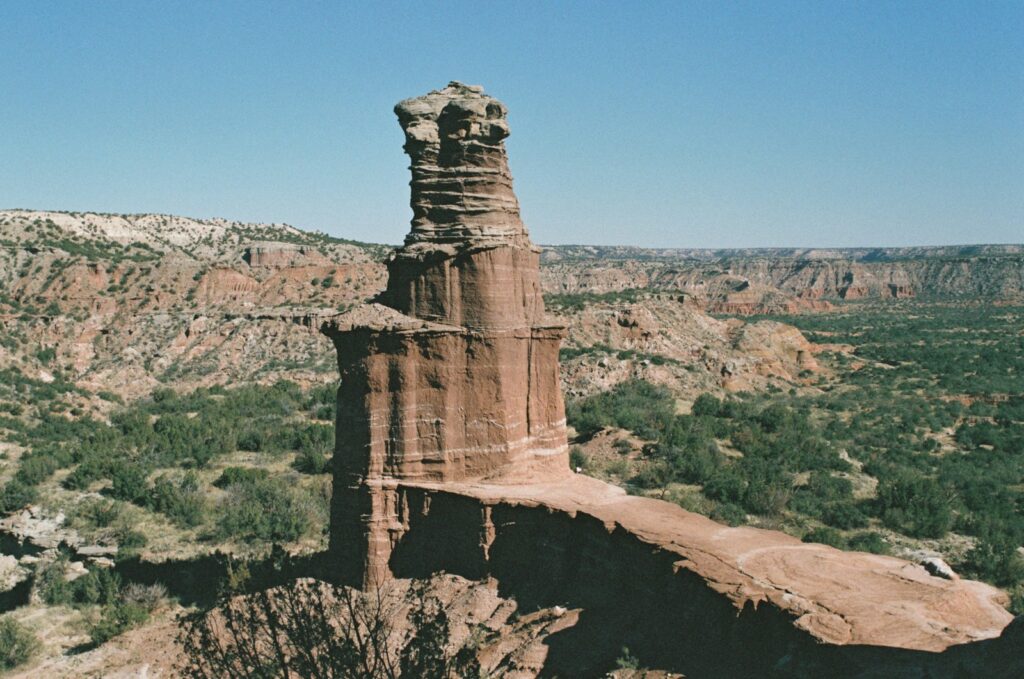 A large rock formation in the middle of a desert