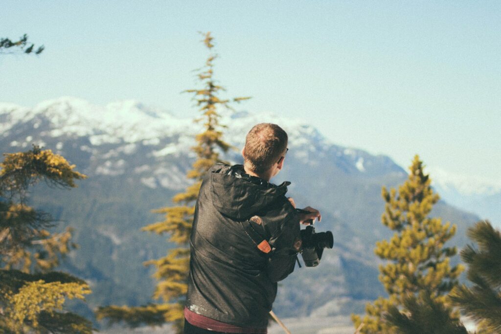 Selective focus photography of man holding camera.