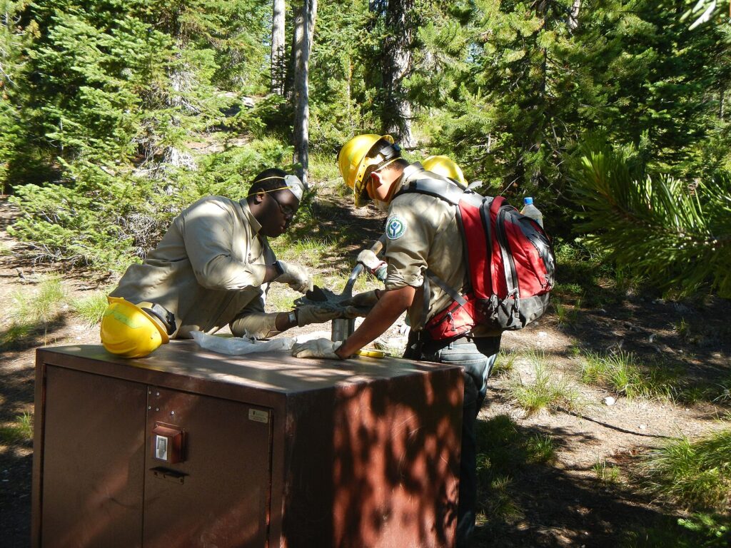 Yellowstone YCC enrollees installing a bear box at Norris Campground in Summer 2014. Each campsite now has a bear box for campers to store their food, coolers, and stoves.