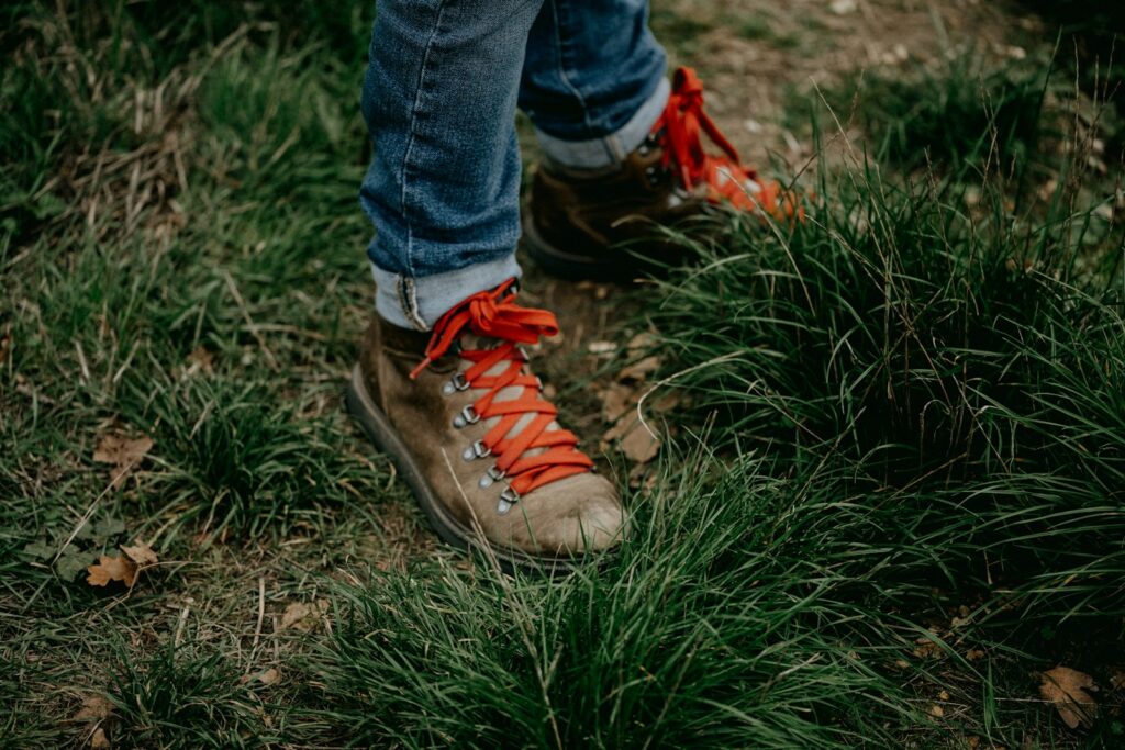 A person's feet in a grassy area.
