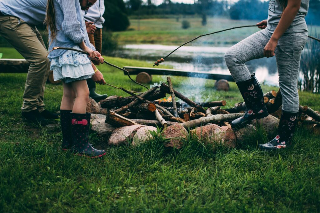 Family camping near body of water during daytime.