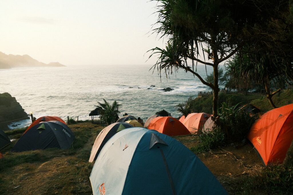 A group of tents sitting on top of a lush green hillside