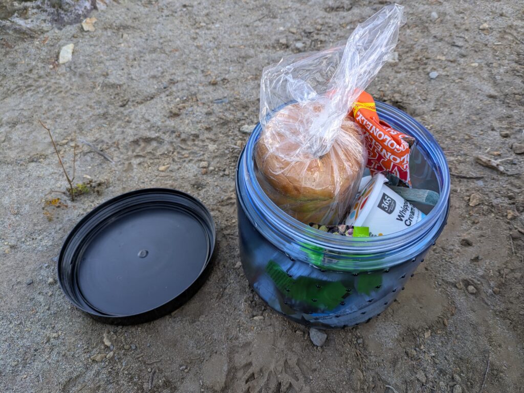 Small bear box for one hiker filled with energy dense food such as bagels and chocolate