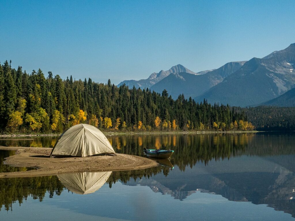 Family camping near body of water during daytime.