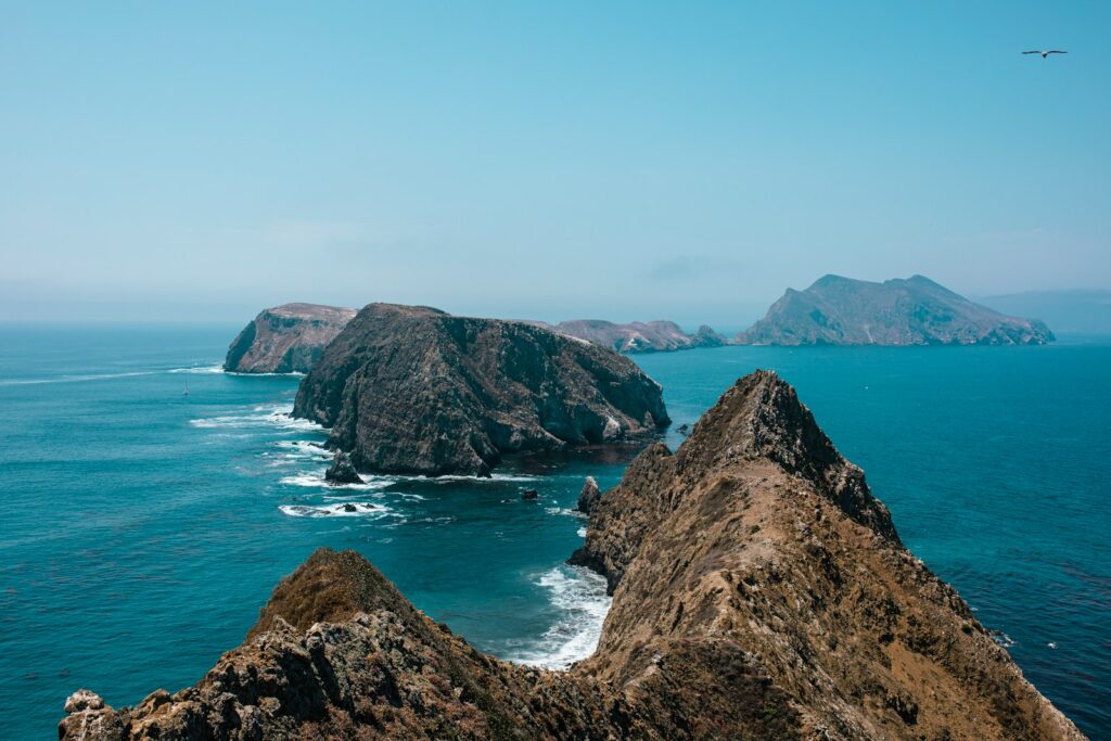 brown rock formation on sea during daytime
