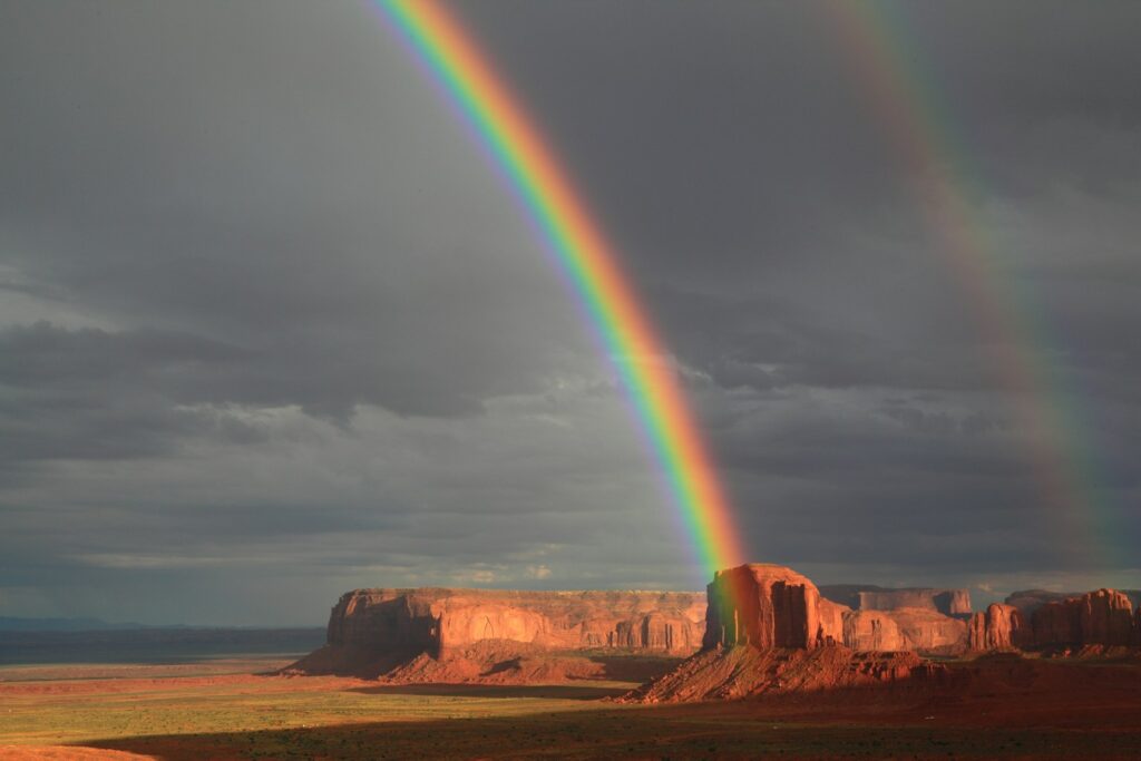 a rainbow over a rocky landscape
