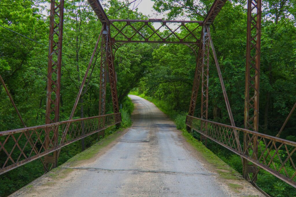 Empty brown wooden bridge during daytime.