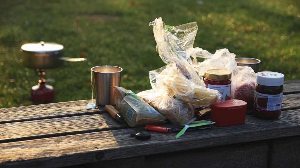 Labeled containers on brown bench.