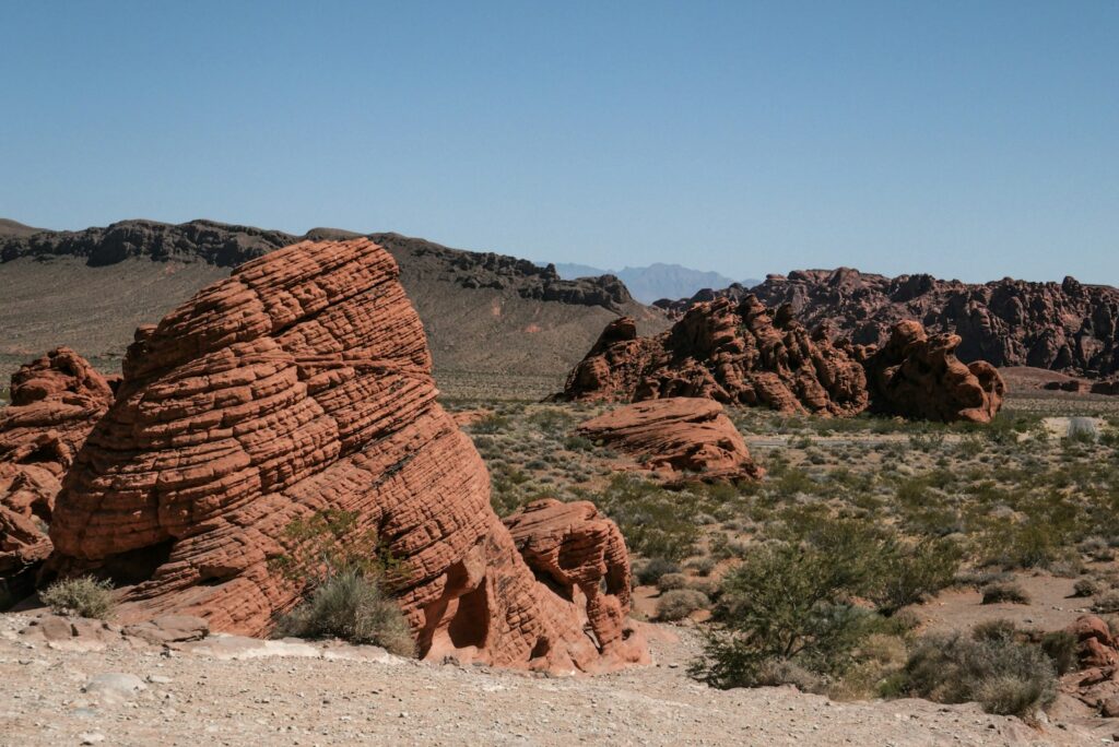 a large rock formation in the middle of a desert