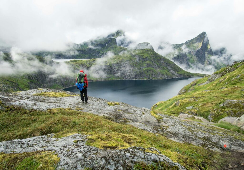 person standing on top of mountain during daytime