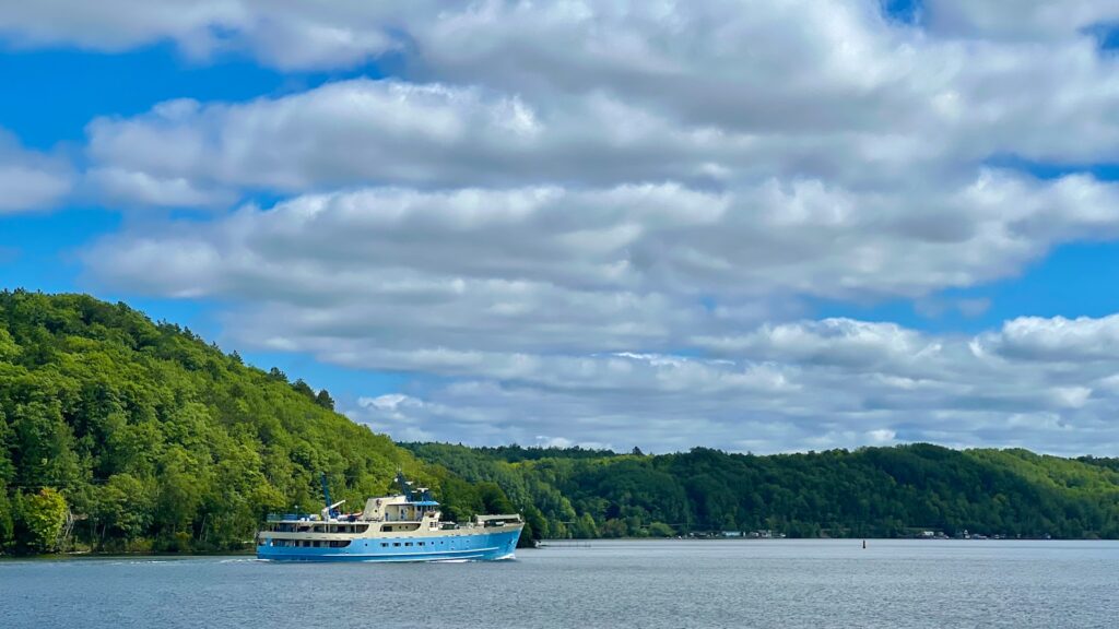 A boat floating on top of a large body of water