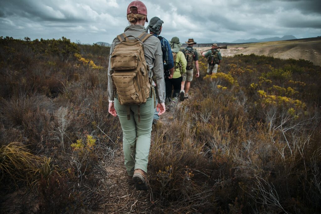 people walking on green grass field during daytime