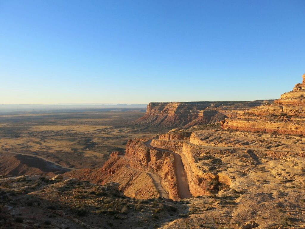 a scenic view of a canyon with a blue sky in the background