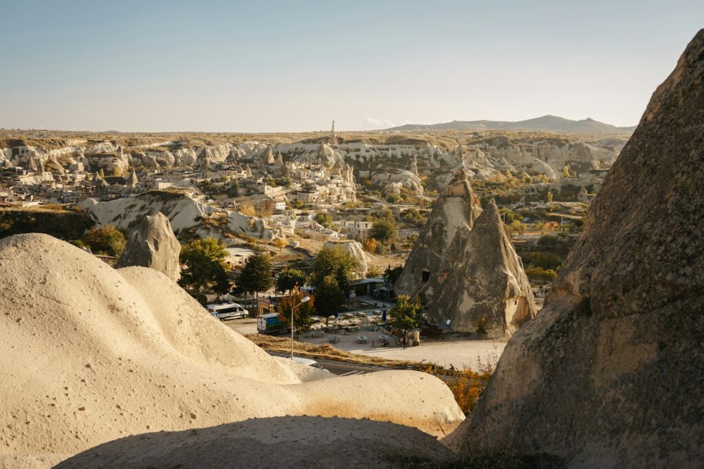 a rocky landscape with a road with Cappadocia in the background
