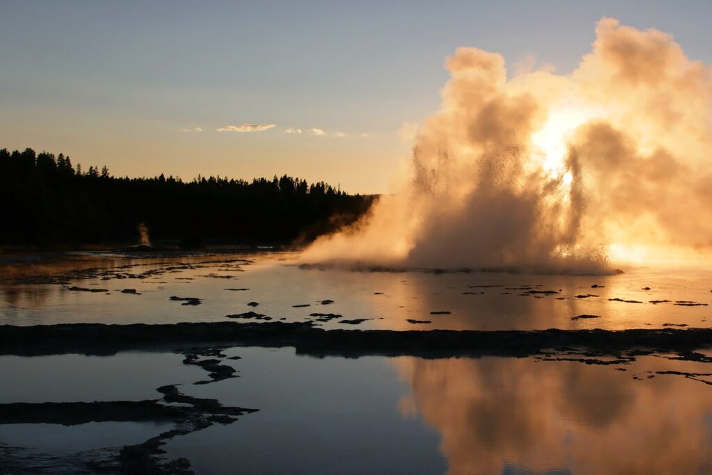A powerful geyser spouts steam and water in Yellowstone National Park, highlighting the natural beauty of Wyoming, USA.