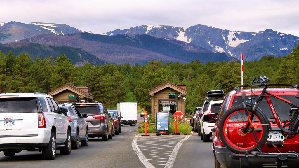 A vibrant red car with a bicycle securely mounted on its rear, ready for an adventurous outing.